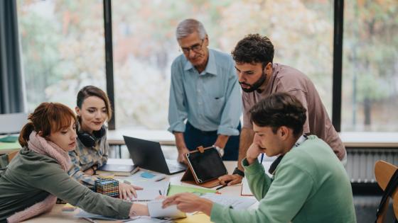 group of university students working with their professor