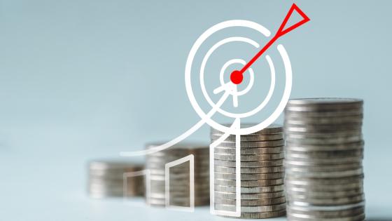 Piles of coins and illustration of dart hitting board