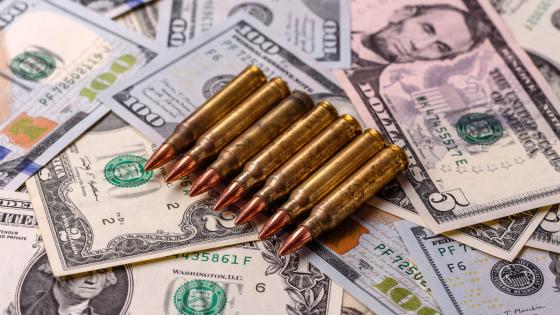 Bullets on top of dollar bills