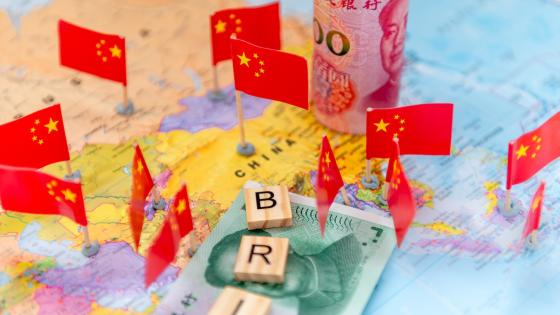 Letter tiles, Chinese Yuan bank notes and national flags on a word map
