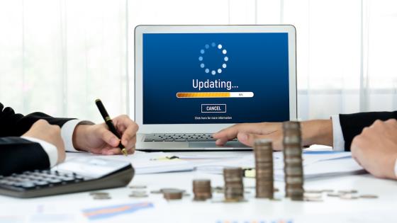 Software updating on laptop in office