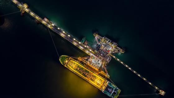 oil tanker loading from oil station at night