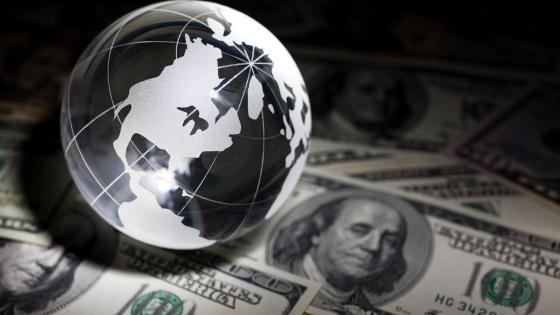 Glass globe and US dollar bills