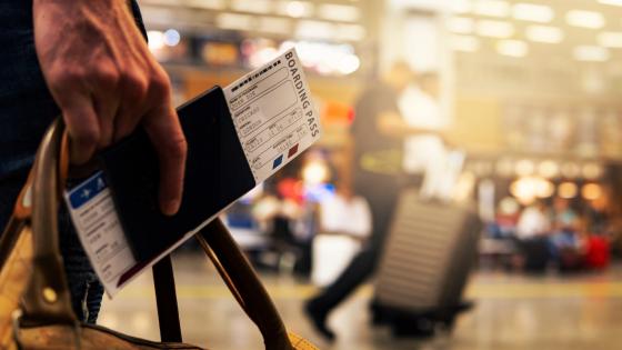 Man carrying passport and boarding pass in airport