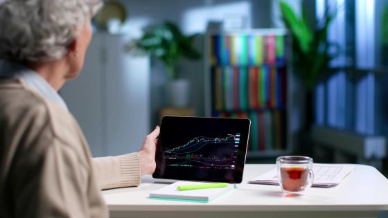 Older woman looking at financial chart on tablet