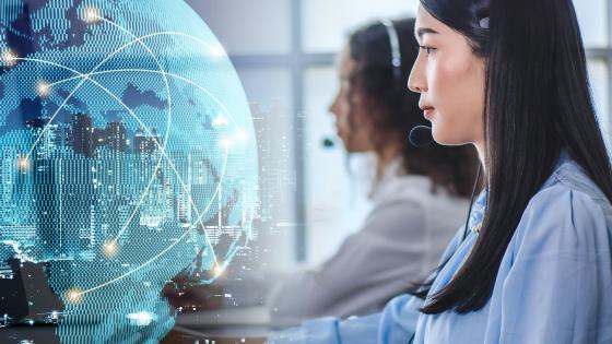 Women using headsets with 3D image of globe