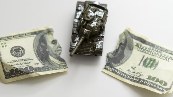 Dollar bill torn apart by model tank
