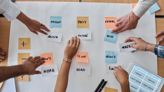 Adult students learning English verbs