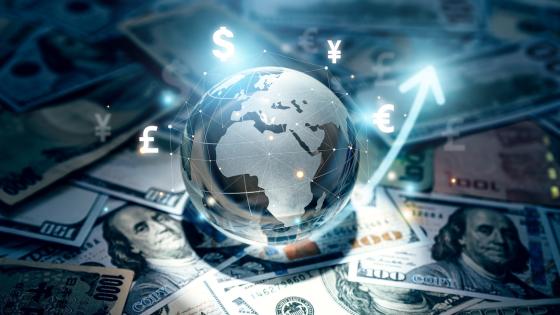 Glass globe and world currencies