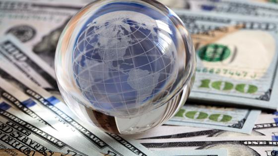 Glass globe on US dollar bills