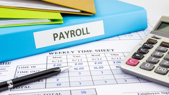 Timesheet, payroll folder and calculator