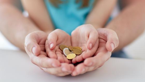 close up of family hands holding euro money coins