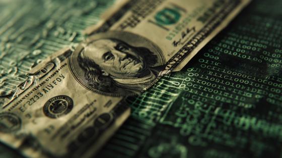 Old banknote on top of computer code