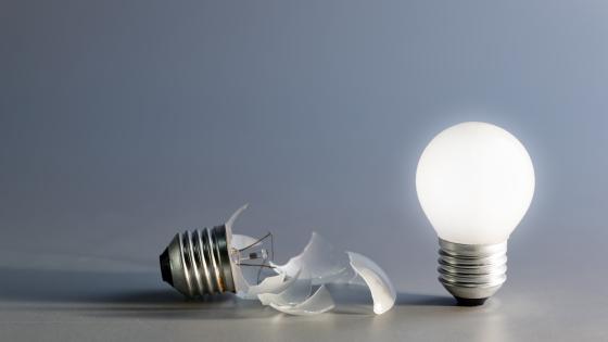 broken and glowing lightbulb